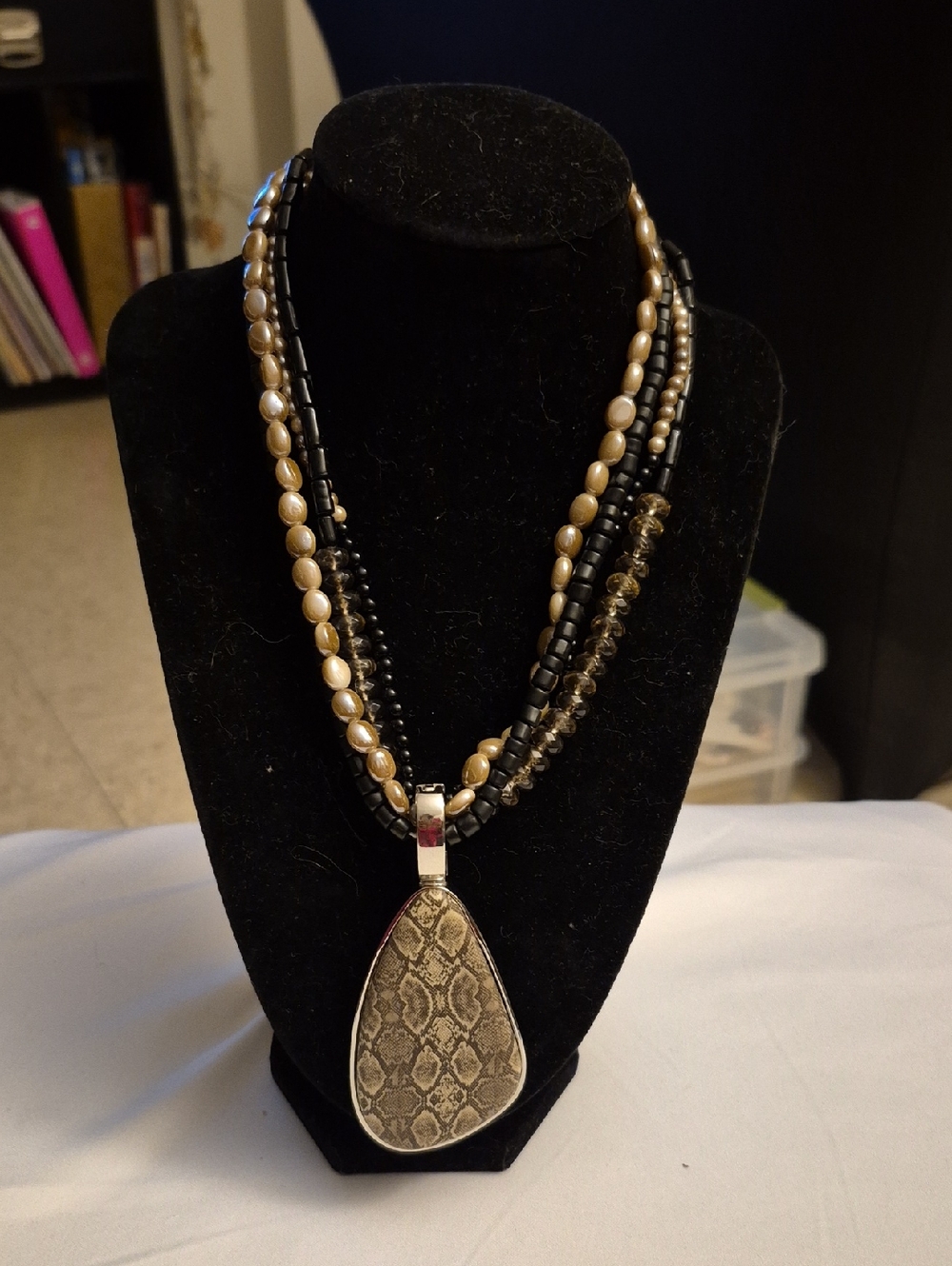 Multi-Strand Black and Gold Beaded Necklace with Snake-Print Pendant